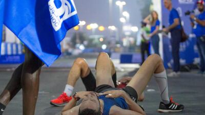 10K Marathon finishers collapsing of tiredness at the Adnoc Abu Dhabi Marathon. Leslie Pableo for The National