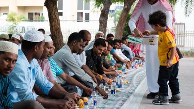 Food is distributed to men breaking their fasts at Jumeirah Grand Mosque in Dubai on the first day of Ramadan. Duncan Chard for The National