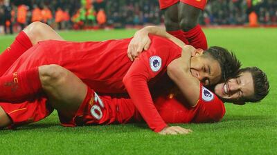 Roberto Firmino of Liverpool celebrates with Adam Lallana after Firmino scored Liverpool's second goal against Stoke City at Anfield on December 27, 2016 in Liverpool, England. Alex Livesey / Getty Images