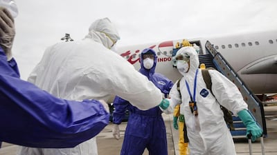 Indonesian health officials arrive from Wuhan, China. The virus has now spread to nearly 26 countries and claimed more than 300 lives. EPA