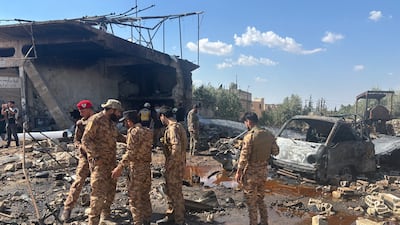 Local authorities examine the scene after munitions detonated while being transferred from a vehicle to a warehouse in Binnish, north-west Syria, on Tuesday. Ahmad Fallaha / The National