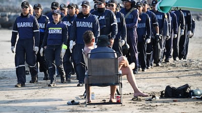 Tourists watch as navy personnel arrive to inspect tar slicks on Caracol Beach in Boca del Rio, Mexico. Reuters