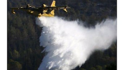 A Turkish plane drops water over a forest fire near Ein Hod, on Mount Carmel, near Haifa, Israel, yesterday. Some have speculated that Istanbul's assistance could pave the way for an easing of tensions between Israel and Turkey. Amir Cohen / Reuters