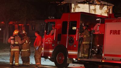 Rescue workers gather near a damaged apartment complex. AP Photo/ Waco Tribune Herald / Rod Aydelotte