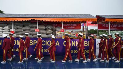 School pupils file past the drugs haul in Yangon. AFP