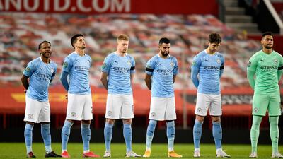 Manchester City players observe a minute of silence prior to kick off in memory of Colin Bell. Getty
