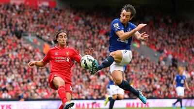 Leighton Baines of Everton tackles Lazar Markovic of Liverpool during their 1-1 draw on Saturday at Anfield. Alex Livesey / Getty Images