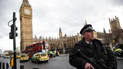 An armed police officer stands guard near Westminster Bridge and the Houses of Parliament in March 2017. Getty Images