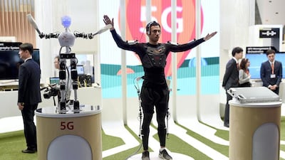 A man operates an SK telecom robot during the 2015 Mobile World Congress in Barcelona. Josep Lago / AFP