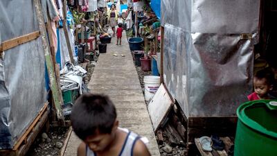 Children play among houses in a temporary bunk house complex on April 16, 2014 in Tacloban, Leyte, Philippines. Chris McGrath / Getty Images
