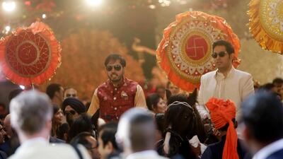Isha brother's Anant Ambani, left, and Akash Ambani ride horses as part of the wedding procession. Reuters
