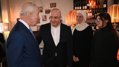 King Charles speaks with Mr Al Arnab at Imad's Syrian Kitchen. PA