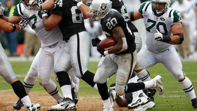 Oakland Raiders running back Darren McFadden (20) carries the ball on a 70-yard touchdown run against the New York Jets during the second quarter of an NFL football game in Oakland, Calif. Sunday, Sept. 25, 2011. Paul Sakuma / AP Photo