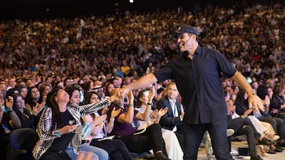 Tony Robbins high fived and fist pumped with the crowd as he walked past people