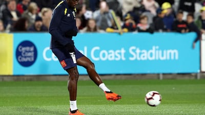 Usain Bolt warms up before making his first appearance for Central Coast Mariners. AFP