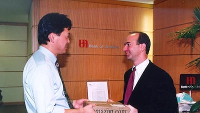 Jeff Bezos delivers an Amazon order to the company's one millionth customer in Tokyo, Japan, in October 1997. Photo: Amazon