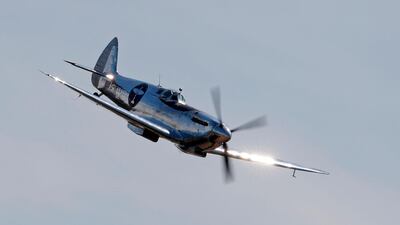 British aviator Matt Jones flies over the airfield after taking off in the Silver Spitfire. Adrian Dennis / AFP