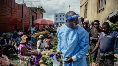 The head of a community group in Goma, DR Congo, wears protective equipment as he raises awareness of Ebola prevention measures. AFP