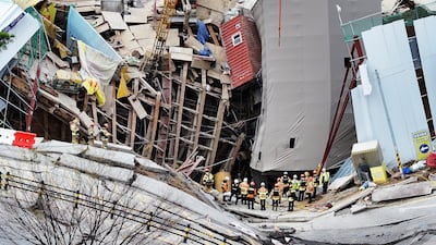 South Korean firefighters work at the scene of a collapsed subway construction site in Gwangmyeong on April 12. AP