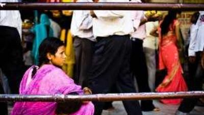 A woman begs outside a shrine in south New Delhi. Officials have threatened beggars with arrest, fines and deportation.