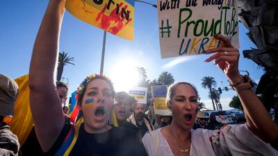 Demonstrators carry flags during a rally in support of Ukraine in Santa Monica, California. AFP
