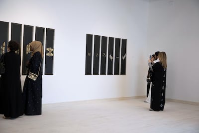 A woman takes a picture of an art work at Makan gallery in Jeddah. Willy Lowry / The National