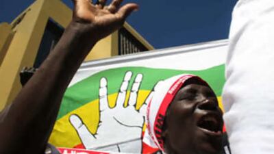 Opposition supporters gather outside the venue for the signing of a deal that will see Robert Mugabe cede some power to opposition leader Morgan Tsvangirai.