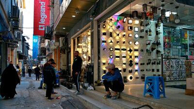 Street vendors wait for customers in the main Shurja market in Baghdad, Iraq. The country devalued its currency by about 23 per cent against the US dollar on December 20, the first time the peg was adjusted since 2015. Photo: AP