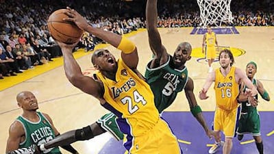 The Los Angeles Lakers guard Kobe Bryant drives to the basket, holding off the attentions of Boston's Kevin Garnett during Game 6 of the NBA finals on Tuesday, which the Lakers won to level the series at 3-3.