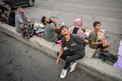 Murat Sengul's photo Drone Attacks in Beirut captures residents looking skywards during an Israeli drone strike. Photo: Anadolu Agency