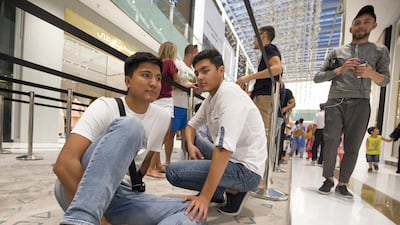 Imat Musaev from Uzbekistan with his friend waiting to get the new iPhone XS at Apple store in Dubai Mall. Leslie Pableo / The National