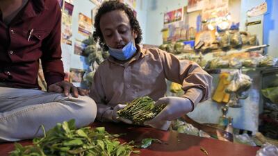 A Yemeni vendor sorts leaves of qat, the ubiquitous mild narcotic, at a market in the capital Sanaa on May 1, 2020. AFP