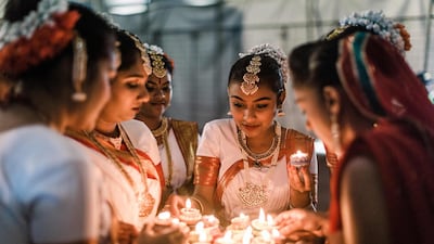 A group of colourful dancers from the Kumari Shiksha Dance Institution light colourful clay lamps in preparation to celebrate Diwali during the two day Diwali (Festival of Lights) Hindu festival celebrations at the old Drive-Inn in Durban, on October 19, 2019. The two-day festival attracts over 100,000 visitors. A billion Hindus worldwide will officially celebrate Diwali on October 27, 2019. AFP
