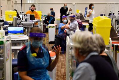 Members of the public receive a dose of a Covid-19 vaccine at a temporary coronavirus vaccination centre set up at Villa Park football stadium, home ground of English Premiere League football team Aston Villa, in Birmingham. AFP