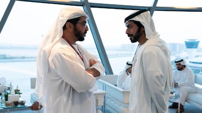 Sheikh Hamdan bin Zayed, Ruler’s Representative in Al Dhafra Region (L) speaks with Sheikh Khalifa bin Tahnoon bin Mohamed Al Nahyan, Director of the Martyrs' Families' Affairs Office of the Abu Dhabi Crown Prince Court (R), on the final day of the 2018 Formula 1 Etihad Airways Abu Dhabi Grand Prix, in Shams Tower. Ryan Carter / Ministry of Presidential Affairs