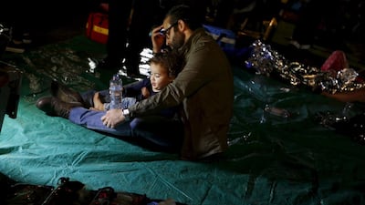 Wounded people are seen outside the Address Downtown Dubai hotel and residential block after a fire engulfed the skyscraper in downtown Dubai. Ahmed Jadallah / Reuters