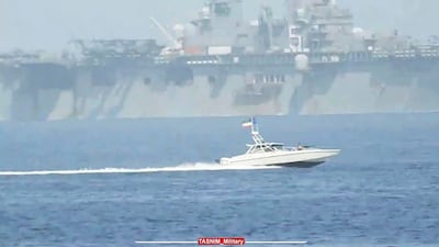 An IRGC speedboat moves alongside the USS Bataan in the Strait of Hormuz in the Arabian Gulf. AP