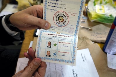 A judge displays the ballot at a polling station in Shubra. Dana Smillie for The National