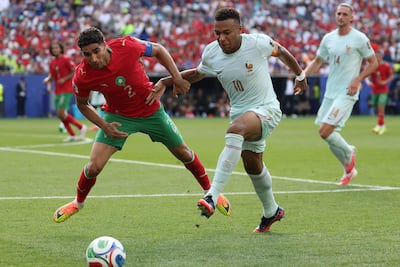 Morocco's Achraf Hakimi vies for the ball with France's Kylian Mbappe. AFP