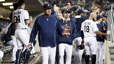 Pitching coach Jeff Jones, centre right, of the Detroit Tigers walks through the dugout with manager Brad Ausmus, centre left, during a game against the Chicago White Sox. Duane Burleson/Getty Images