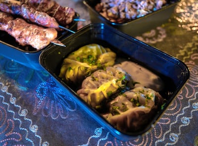 Uzbek dumplings, known as manti, and kebab skewers are served inside the country's pavilion at the Sheikh Zayed Heritage Festival. Victor Besa / The National