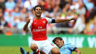 Mikel Arteta of Arsenal clashes with David Silva of Manchester City during the FA Community Shield match between Manchester City and Arsenal at Wembley Stadium on August 10, 2014 in London, England. Photo by Clive Mason/Getty Images