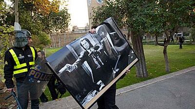 A protester walks with a poster of the film Pulp Fiction after storming the British embassy in Tehran.