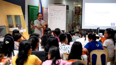 This photo taken on July 6, 2019 shows cultural advocate Leo Emmanuel Castro teaching students the indigenous script known as Baybayin, used before Spanish colonisation in 1521, in Manila. From tattoos, shirts, and artworks to a computer font and mobile apps, Baybayin found a rebirth among millennials and professionals learning its 17 characters beyond the marginal mention in history class. Photos: AFP / Noel Celis