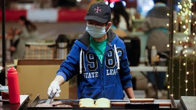 Burgers are prepared at a food stall at Al Aali Mall. Outdoor eating remains popular in Bahrain during winter. Reuters