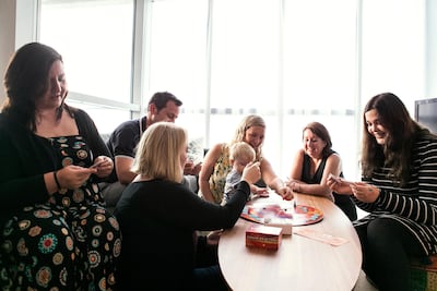 Lorna King ( in yellow) and her friends get together for 'Saturday games night' at her home in Abu Dhabi to reduce the cost of going out. Reem Mohammed / The National