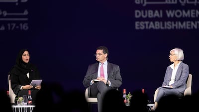 Hessa Buhumaid, Pedro Conceicao, director of Human Development Report Office at the UNDP, and Caren Grown on stage. Reem Mohammed / The National