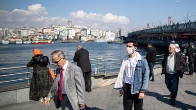 A man wearing a face mask walks near the Bosphorus in Istanbul, Turkey. EPA