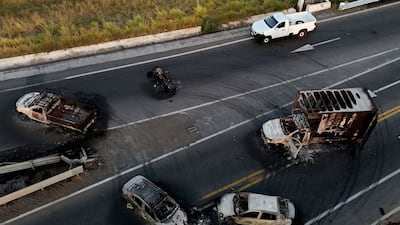 The burnt shells of vehicles are left scattered on a motorway in Jalisco state. AFP