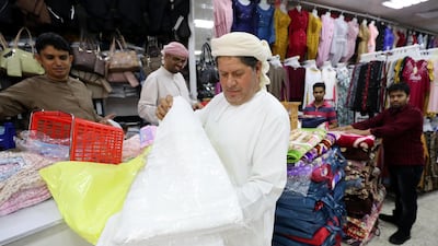 Mohammed Barakat 45, from Egypt, inspects a Ihram at Salmin Trading Shops.